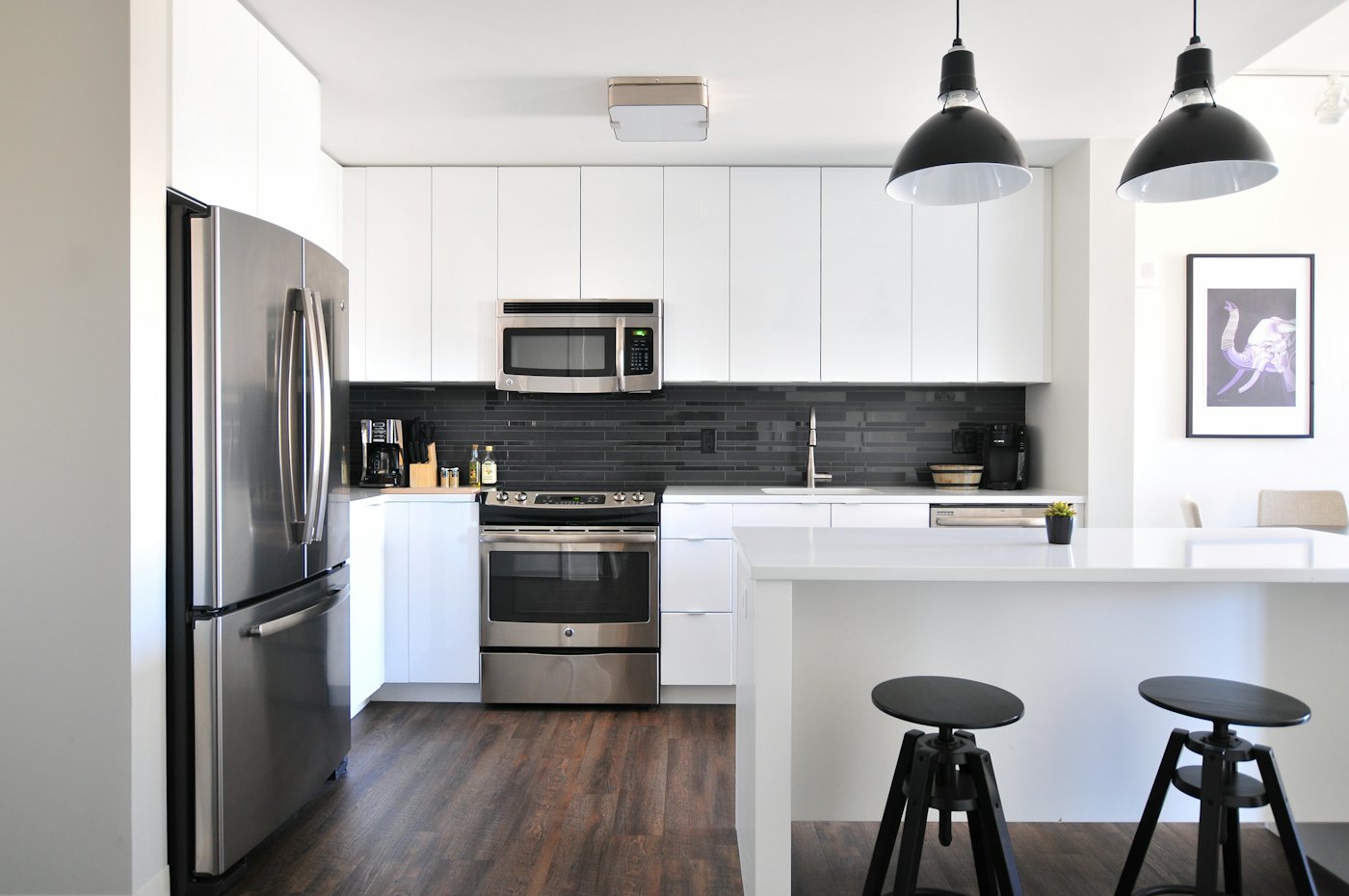 Bright kitchen with white cabinetry and pendant lights